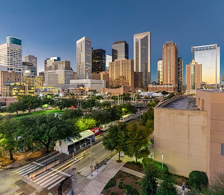 Aerial view downtown Houston illuminated at twilight with green